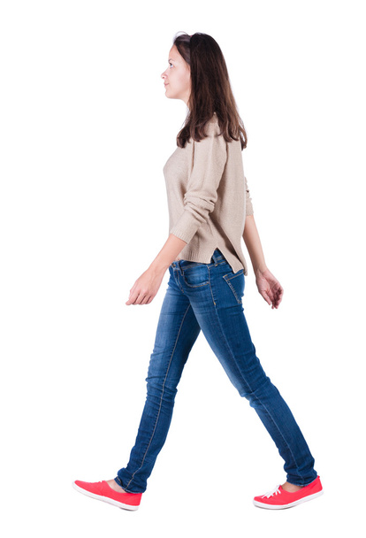 back view of walking woman in jeans . - Foto, afbeelding