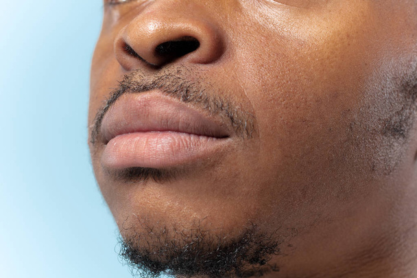 Close up portrait of young man on blue background. - Photo, Image