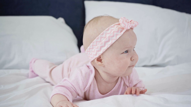 selective focus of adorable infant rolling over on bed  - Footage, Video