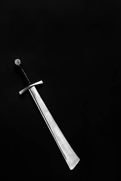 Medieval falchion on a dark background. Place for text. - Foto, immagini