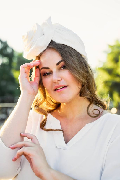 Gorgeous young woman in outstanding headdress posing  - Fotografie, Obrázek