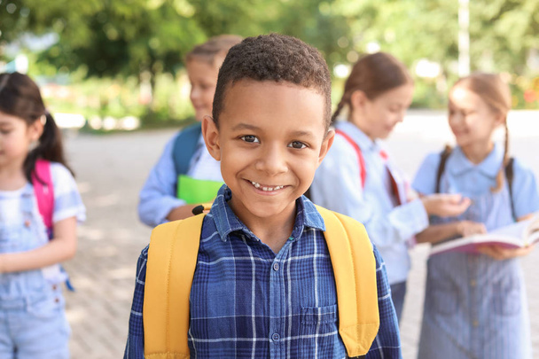 Cute little African-American schoolboy outdoors - Foto, afbeelding