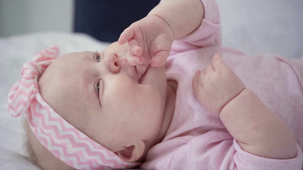 selective focus of cute baby sucking fingers  - Filmati, video
