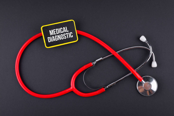Stethoscope on black background with text. MEDICAL CONCEPT - Photo, Image