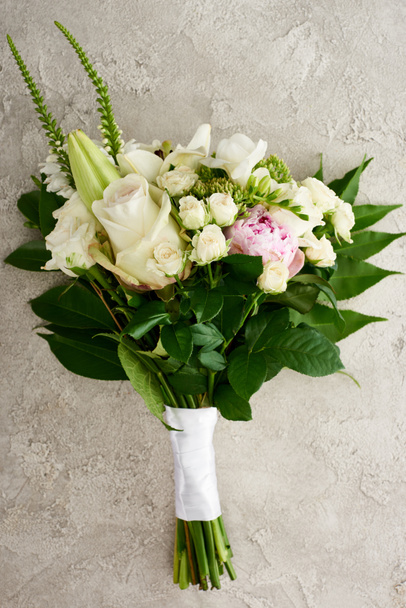 top view of wedding bouquet with roses and eustoma flowers on textured surface - Photo, Image