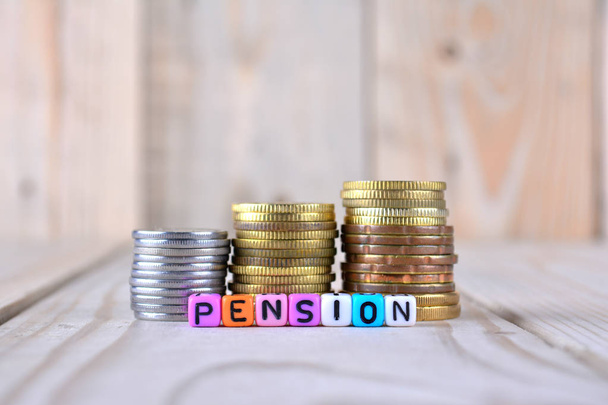 Coins and cube dices with word pension - Photo, Image