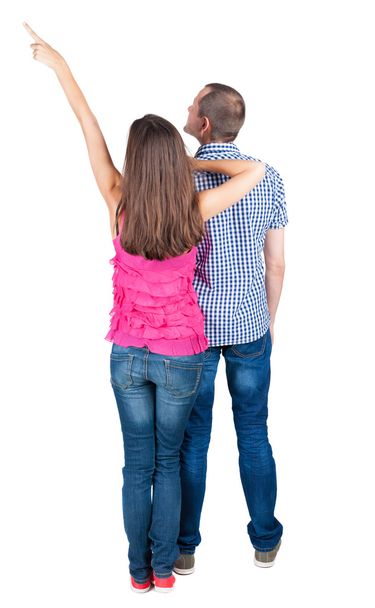 Young couple pointing at wal Back view - Photo, Image