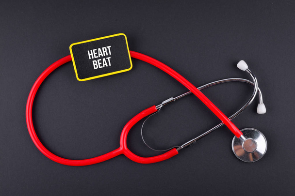 Stethoscope on black background with text. MEDICAL CONCEPT - Photo, Image