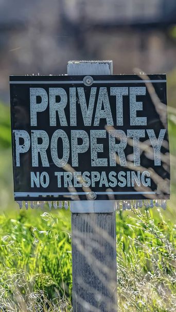 Vertical Close up of a Private Property No Trespassing sign on a sunny day - Photo, Image