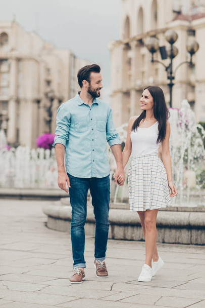 Fulll length body size view photo positive cheerful people millennial free time voyage weekend tourist visitor buildings fountain content rejoice fun denim jeans shirt blue dress sneakers bearded - Foto, imagen