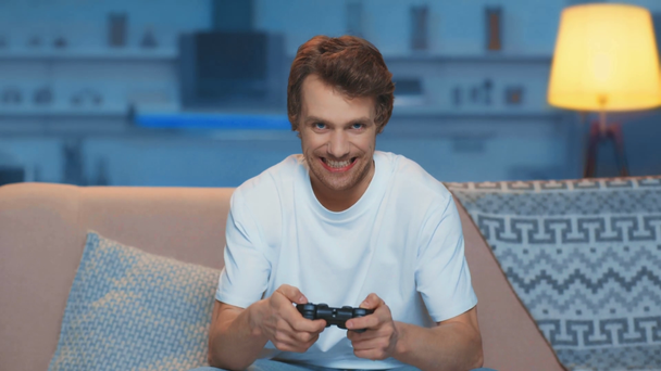 KYIV, UKRAINE - MARCH 12, 2019: angry man playing video game in living room - Filmagem, Vídeo