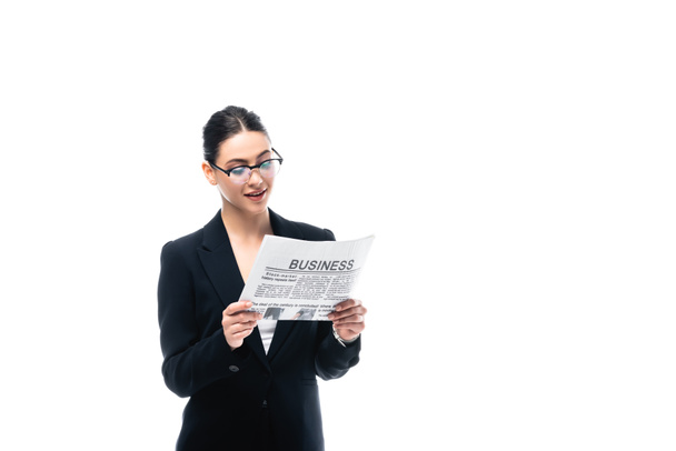 elegant businesswoman in glasses reading business newspaper isolated on white - Foto, imagen