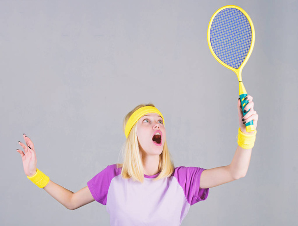 Girl fit slim blonde play tennis. Active lifestyle. Woman hold tennis racket in hand. Tennis club concept. Sport for maintaining health. Tennis sport and entertainment. Active leisure and hobby - 写真・画像