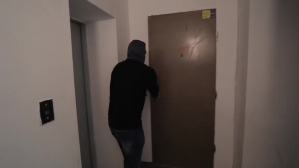 Burglar wearing balaclava mask at crime scene. Housing thief. Burglar in a house inhabited. - Footage, Video