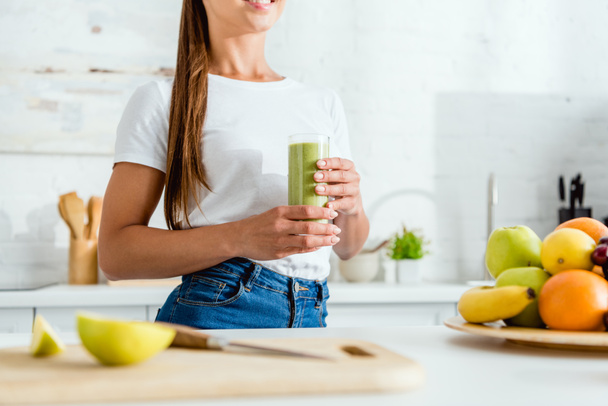 cropped view of girl holding glass with delicious smoothie  - Fotoğraf, Görsel