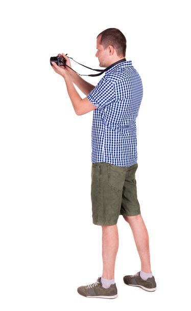 Back view of man photographing. photographer in shorts - Foto, Imagen
