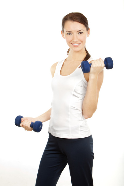 Young brunette woman with dumbells - Foto, Bild