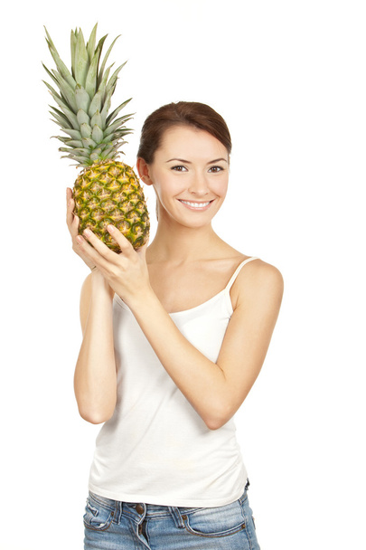 Beautiful brunette holding pineappl - 写真・画像