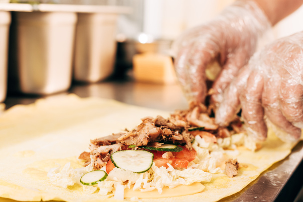partial view of cook in gloves preparing doner kebab - Photo, Image