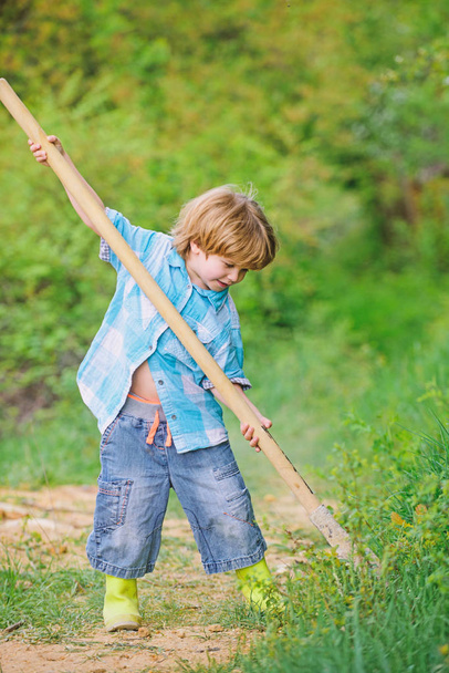 Happy childhood. Adventure hunting for treasures. Little helper working in garden. Cute child in nature having fun with shovel. I want to find treasures. Little boy with shovel looking for treasures - 写真・画像