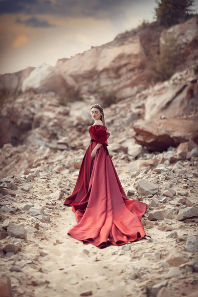 Girl in a red dress with a long skirt - Fotó, kép