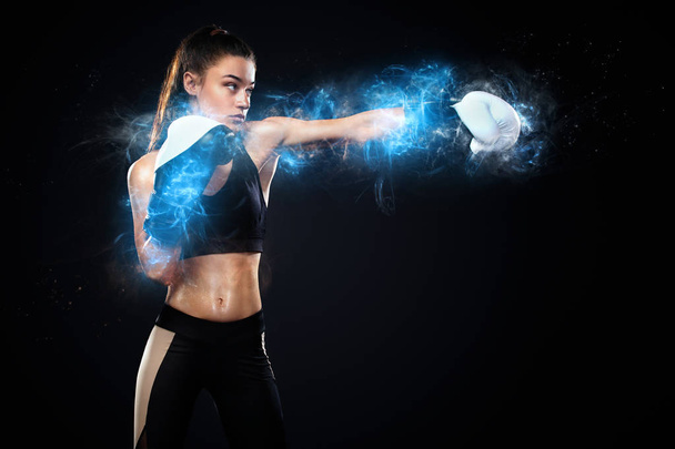 Sportsman, woman boxer fighting in gloves on black background. Boxing and fitness concept. Energy and motivation. - Foto, immagini