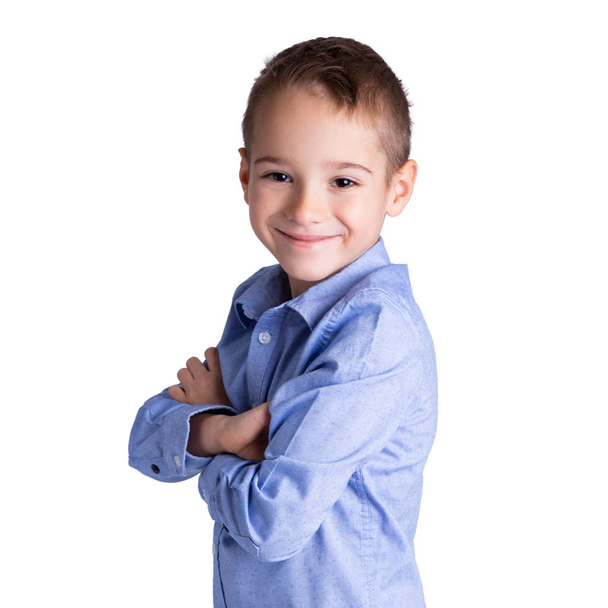 5-6 year old smart boy standing with his arms crossed. Childhood, lifestyle and education concept. - Zdjęcie, obraz