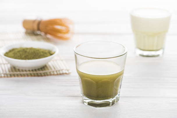 selective focus of traditional green matcha tea on white table  - Foto, afbeelding