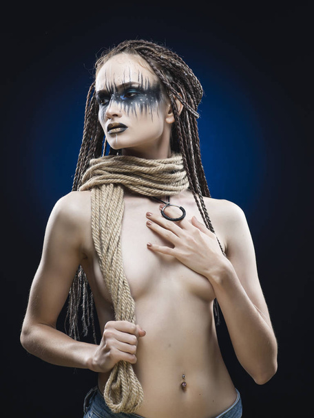 A beautiful young slim girl with avant-garde blue make-up and a  - Fotoğraf, Görsel