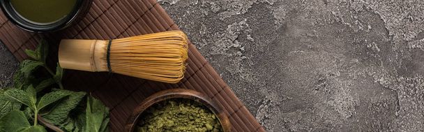 top view of traditional matcha green tea on bamboo mat on dark stone table - Photo, Image