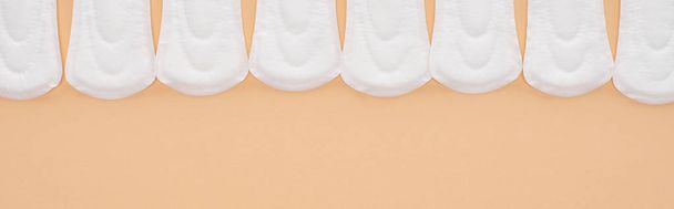 flat lay with white cotton sanitary napkins isolated on beige, panoramic shot - Photo, Image
