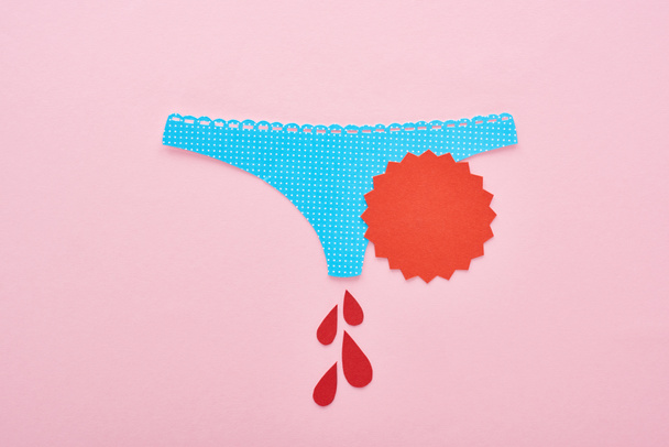 top view of paper cut blue panties with blood drops, menstruation concept - Photo, Image