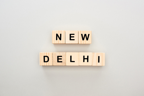 top view of wooden blocks with New Delhi lettering on white background - Foto, afbeelding