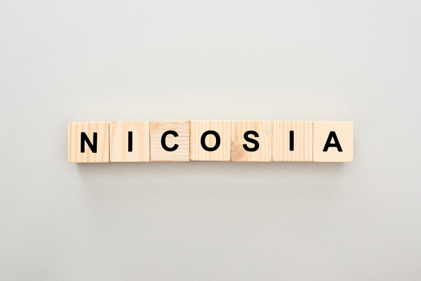 top view of wooden blocks with Nicosia lettering on white background - Zdjęcie, obraz