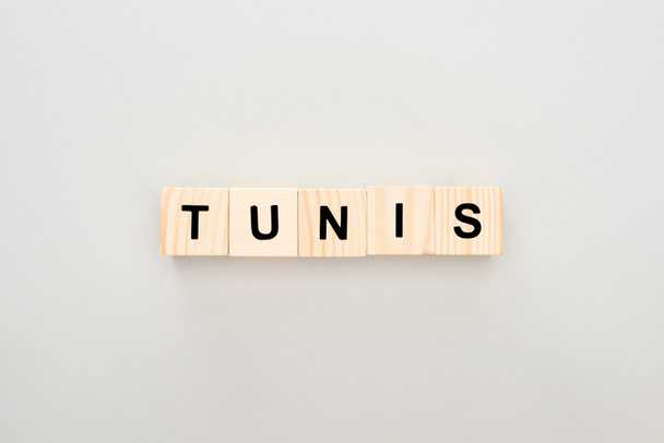 top view of wooden blocks with Tunis lettering on white background - Foto, Imagen