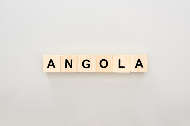 top view of wooden blocks with Angola lettering on white background - Photo, Image
