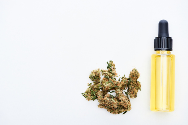 top view of cbd oil and marijuana buds isolated on white  - Φωτογραφία, εικόνα