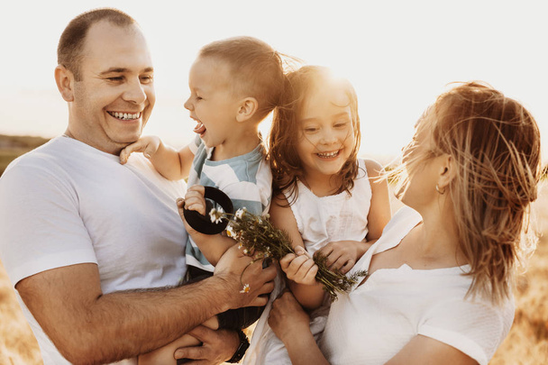 Portrait of a lovely young family laughing while mother and fath - Photo, Image
