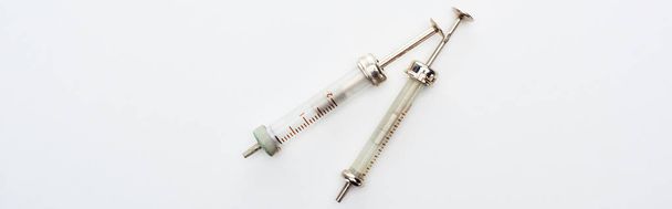 top view of aged syringes on white background with copy space, panoramic shot - Foto, Imagem