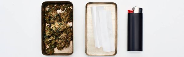flat lay with metal box with marijuana buds and rolling paper near lighter, panoramic shot - Photo, Image