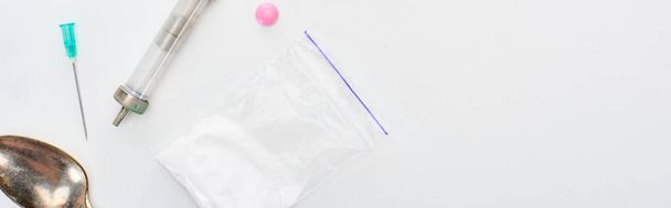 Draufsicht auf Heroin, lsd und Spritze mit Nadel und Löffel auf weißem Hintergrund, Panoramaaufnahme - Foto, Bild