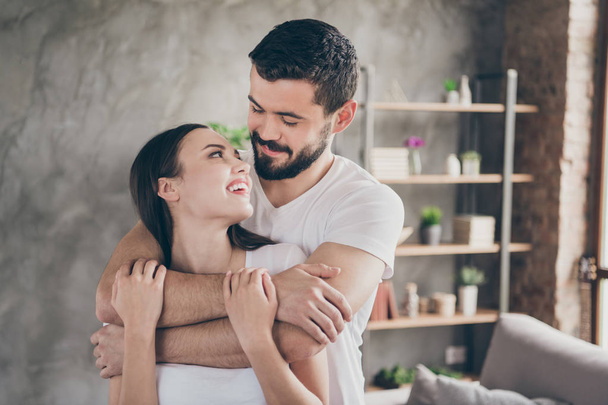 Close-up portrait of his he her she two nice attractive lovely lovable cheerful cheery gentle people sending free spare time honey-moon at industrial loft interior style room house apartment - Foto, afbeelding