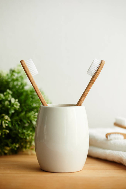 The bamboo toothbrushes in a gray glass - Foto, Imagem