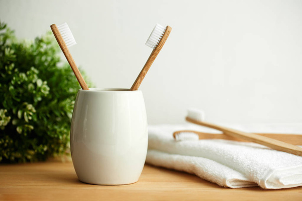 The bamboo toothbrushes in a gray glass with copy space - Фото, зображення