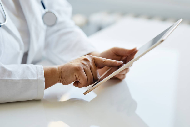 Female doctor presses on screen digital tablet - Foto, Imagen