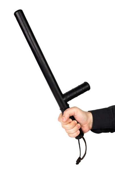 mão em camisa preta com bastão policial de borracha preta isolado no fundo branco
 - Foto, Imagem