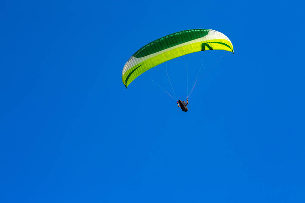 paraglider flying in the blue sky. Paragliding - Fotó, kép