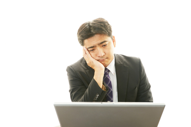 Depressed Asian businessman. - Zdjęcie, obraz
