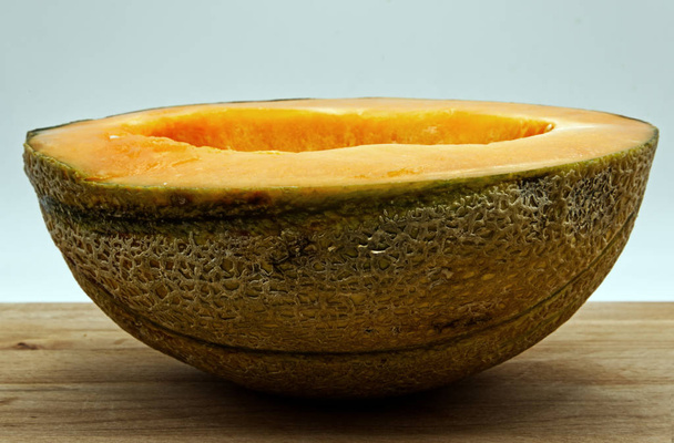 Fresh melon on wooden table, white background - 写真・画像