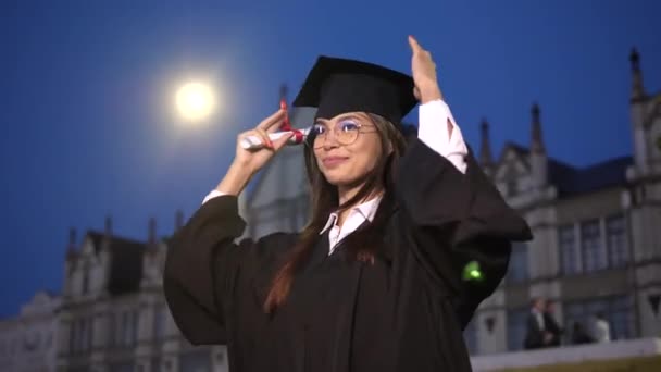 Excited female graduate dancing in academic . - Felvétel, videó
